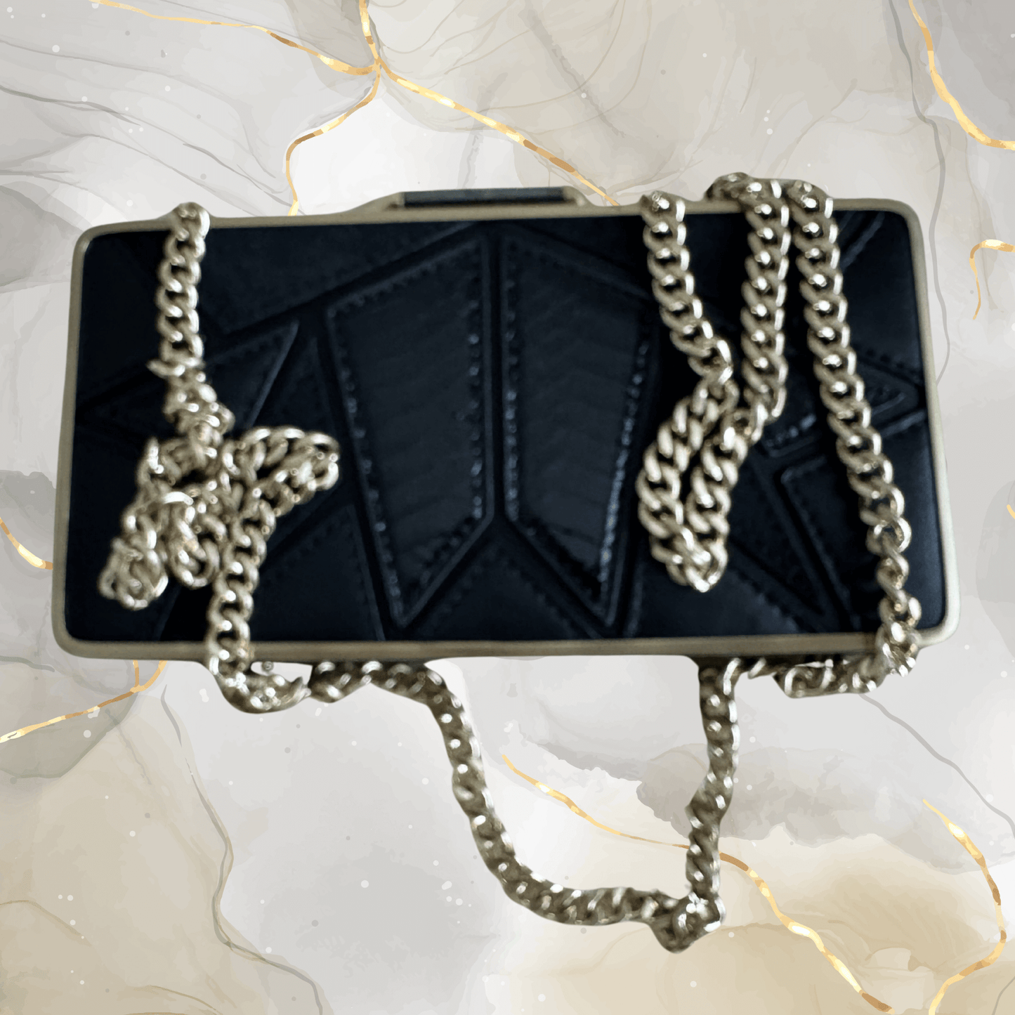 Preowned Brian Atwood black leather clutch with gold frame and chunky chain strap, perfect for evening events.