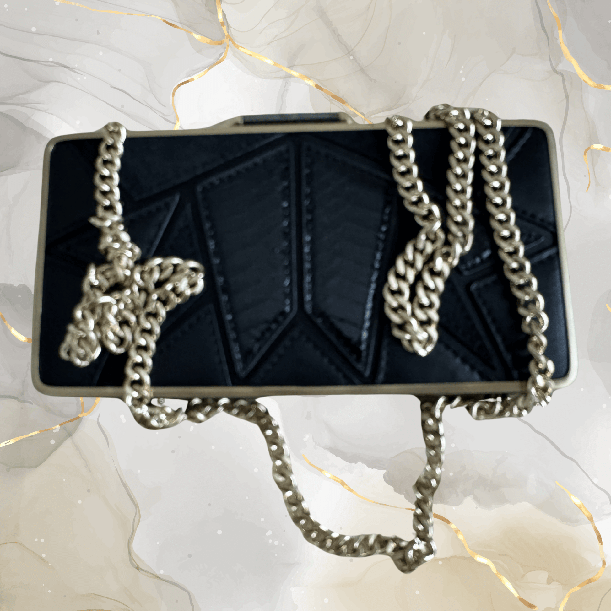 Preowned Brian Atwood black leather clutch with gold frame and chunky chain strap, perfect for evening events.