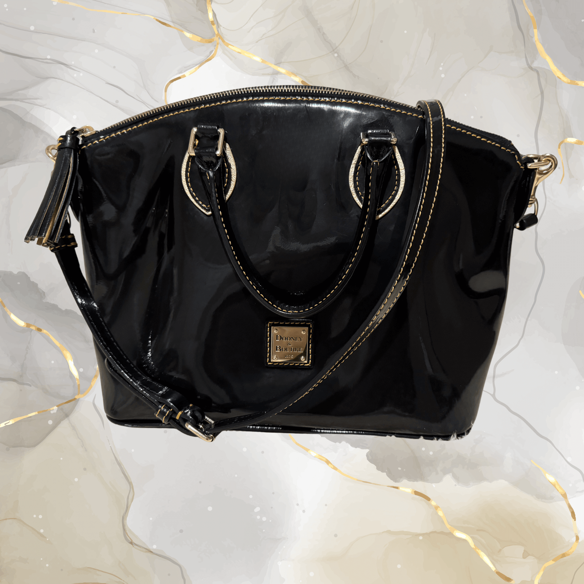 Pre-owned Dooney & Bourke black patent leather tassel satchel bag with gold-tone hardware.